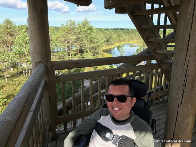 a wheelchair user on an accessible observation tower overlooking the viru bog in estonia