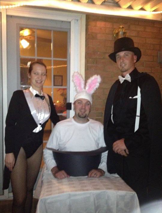 A magician and his assistant pull a rabbit out of a hat