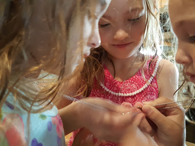 three daughters doing an activity