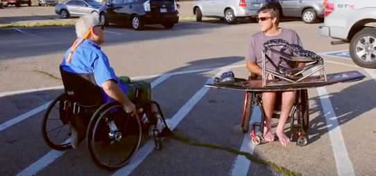 Two wheelchair users preparing to wakeboard