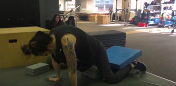 Carissa flexing her back in crawling position