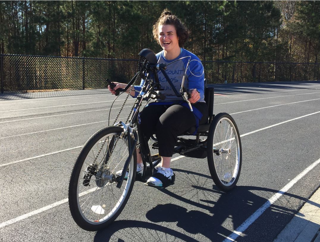 Steph smiling on hand cycle