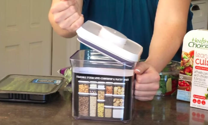 Screenshot of kristen opening reusable container with closed fist