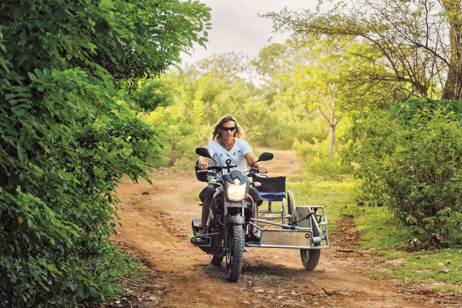 paraplegic rides a customized bike that holds his wheelchair