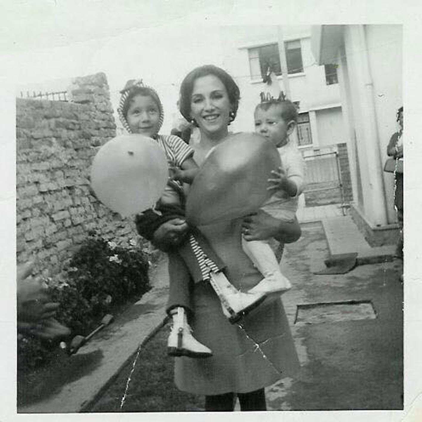 a mother holds her two daughters