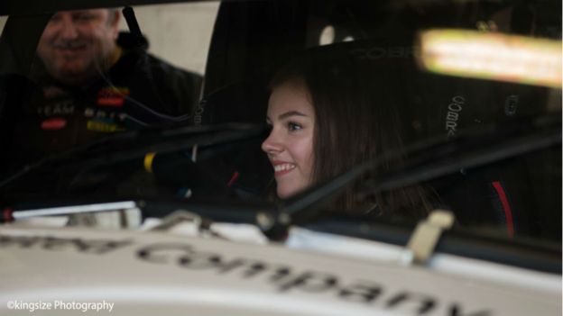 picture of Isabelle sitting in racecar