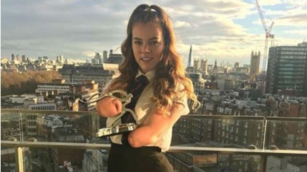 Isabelle holding an award