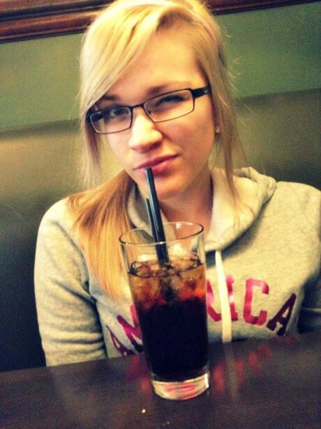 woman sips a soda