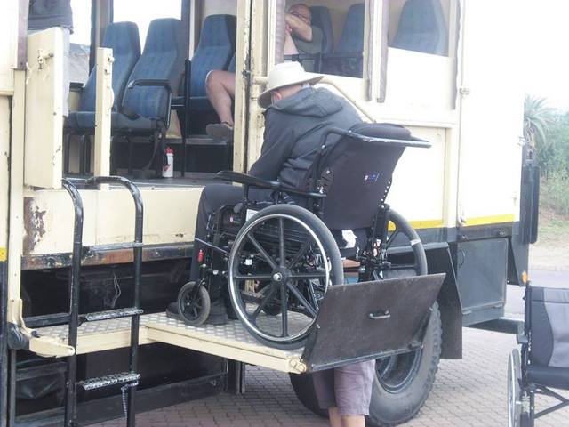 picture of person in wheelchair loading the accessible safari bus