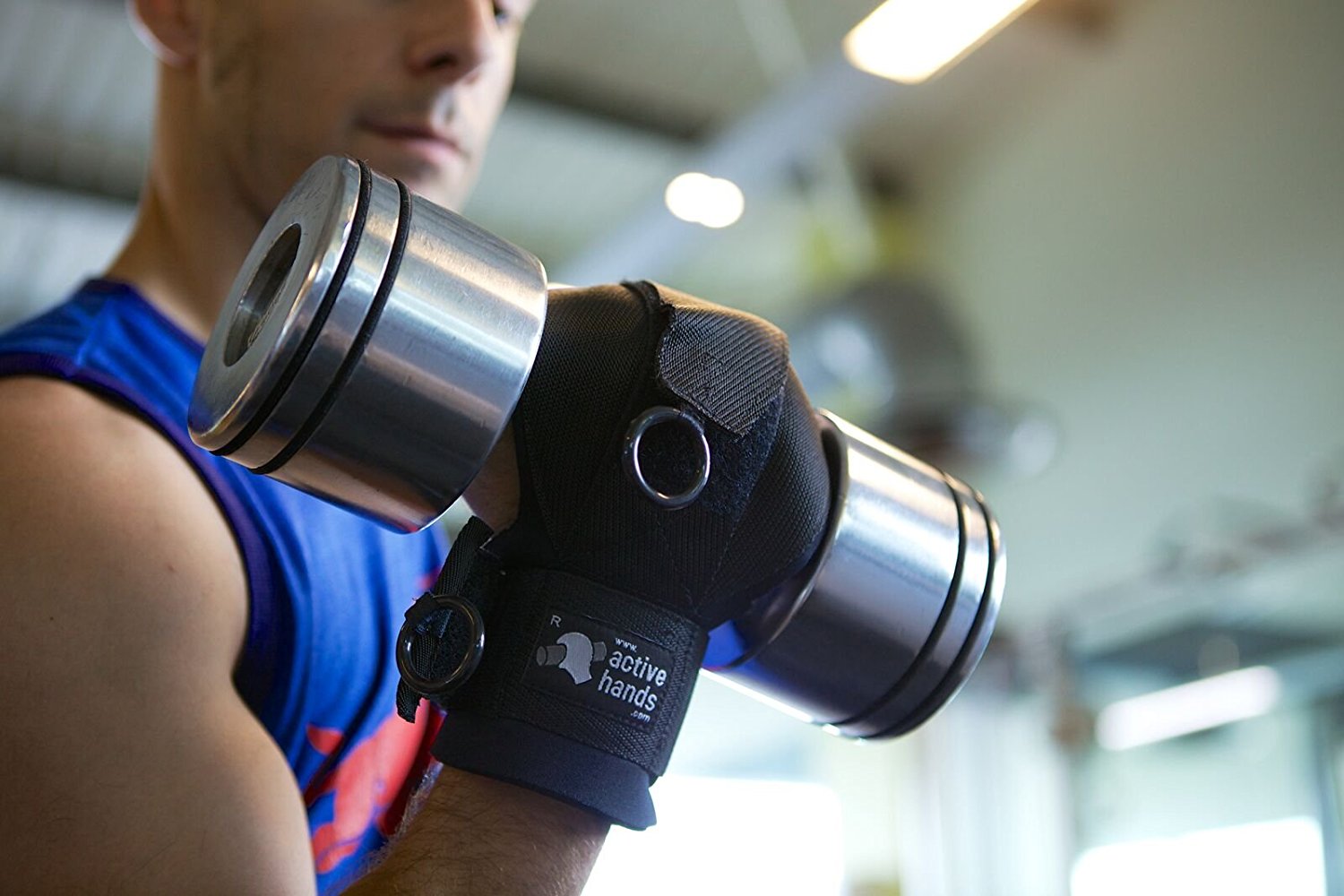 a man uses Active Hands gripping aid to lift a dumbell