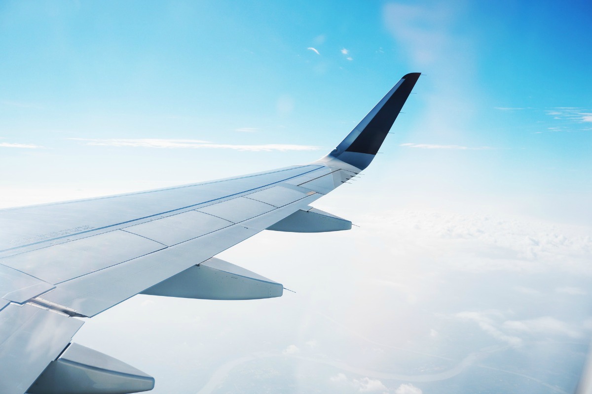 View from airplane of the airplane's wing and the sky