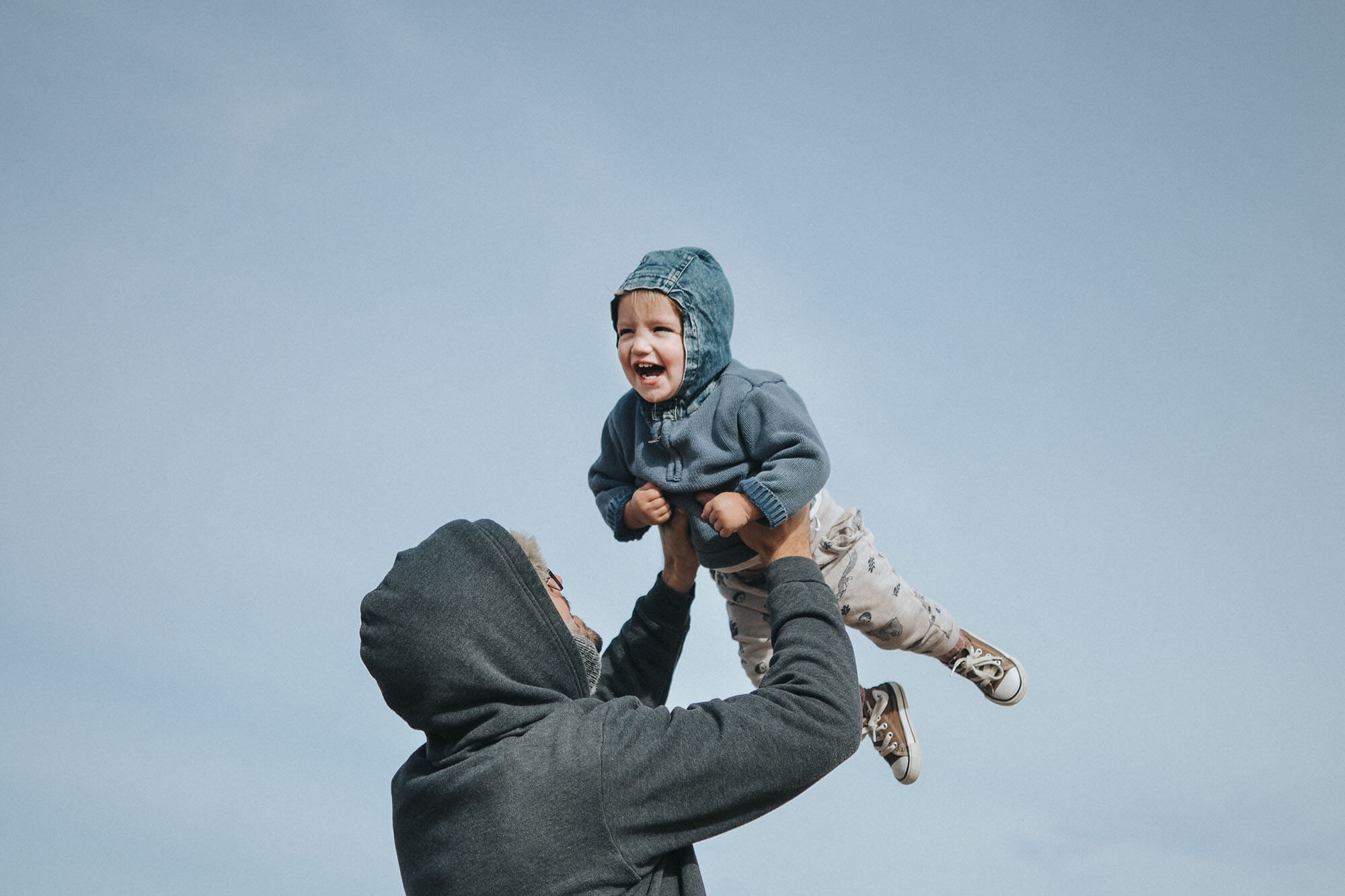 Picture of Fritz being held up in the air by his dad