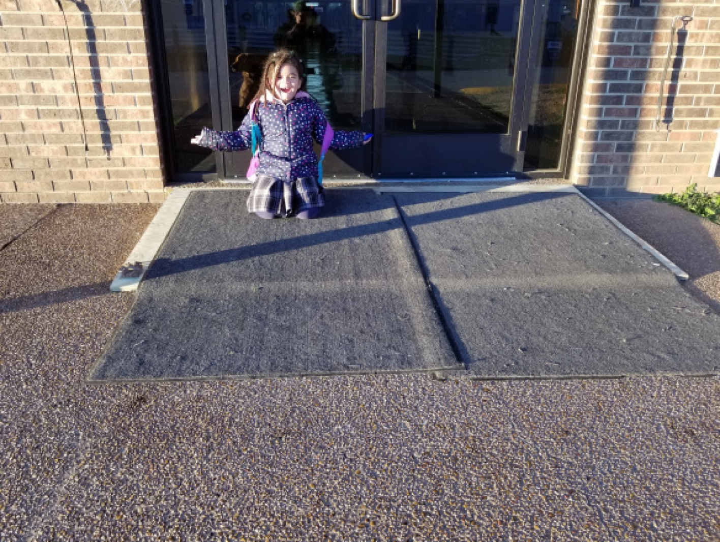 Lyllyan's daughter posing on the ramp her school built for her mom