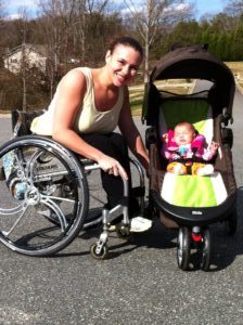 Kristina with her baby who is sitting in her stroller.