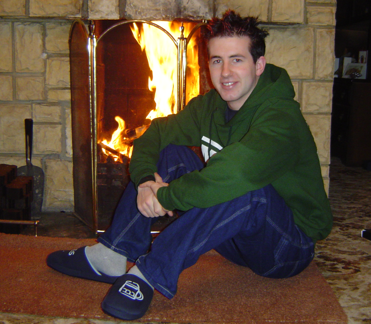Gareth in front of fireplace