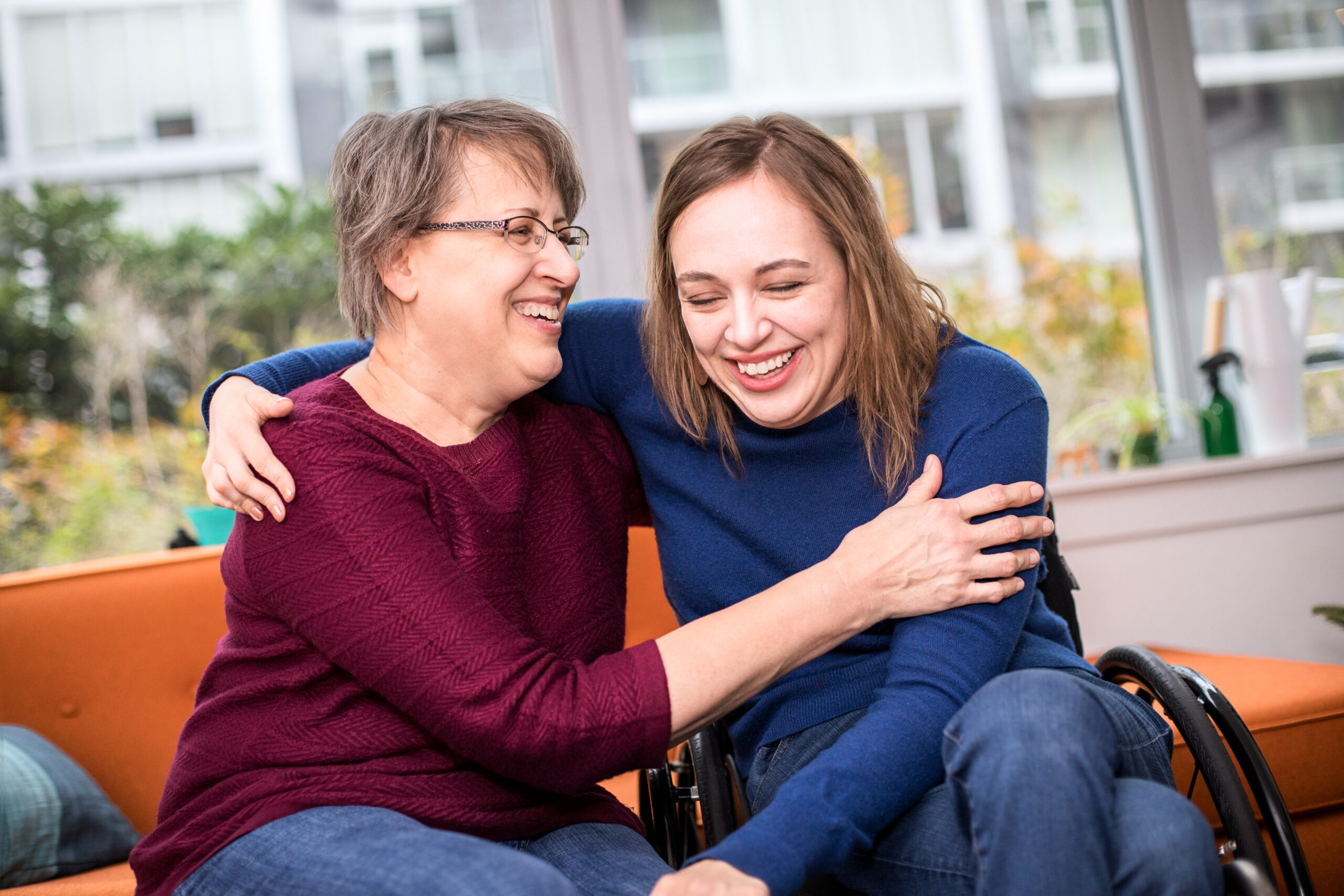 Cindy and Beth embracing while laughing