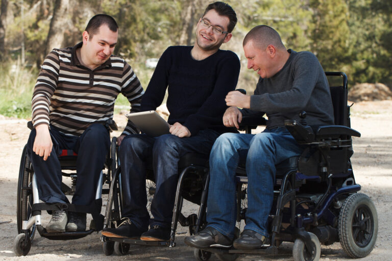 Disabled Happy friends with digital tablet outside