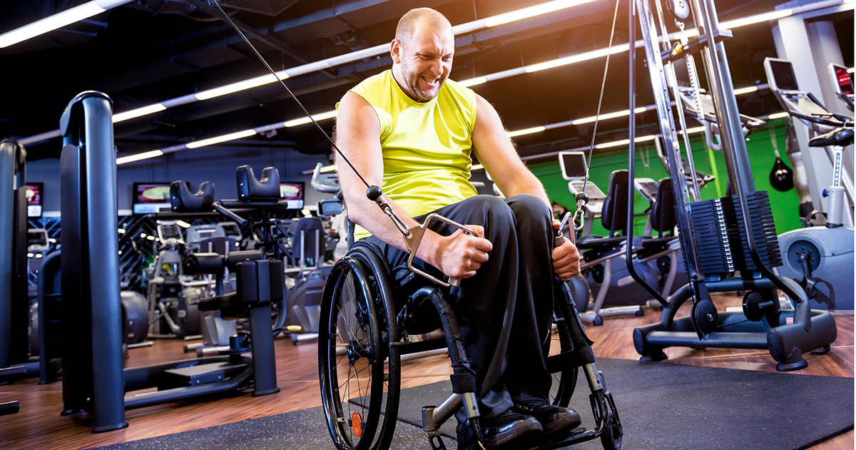man in wheelchair working out in a gym
