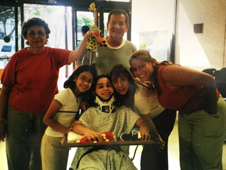 Folgueiras family gathered arounf young David wearing neck brace