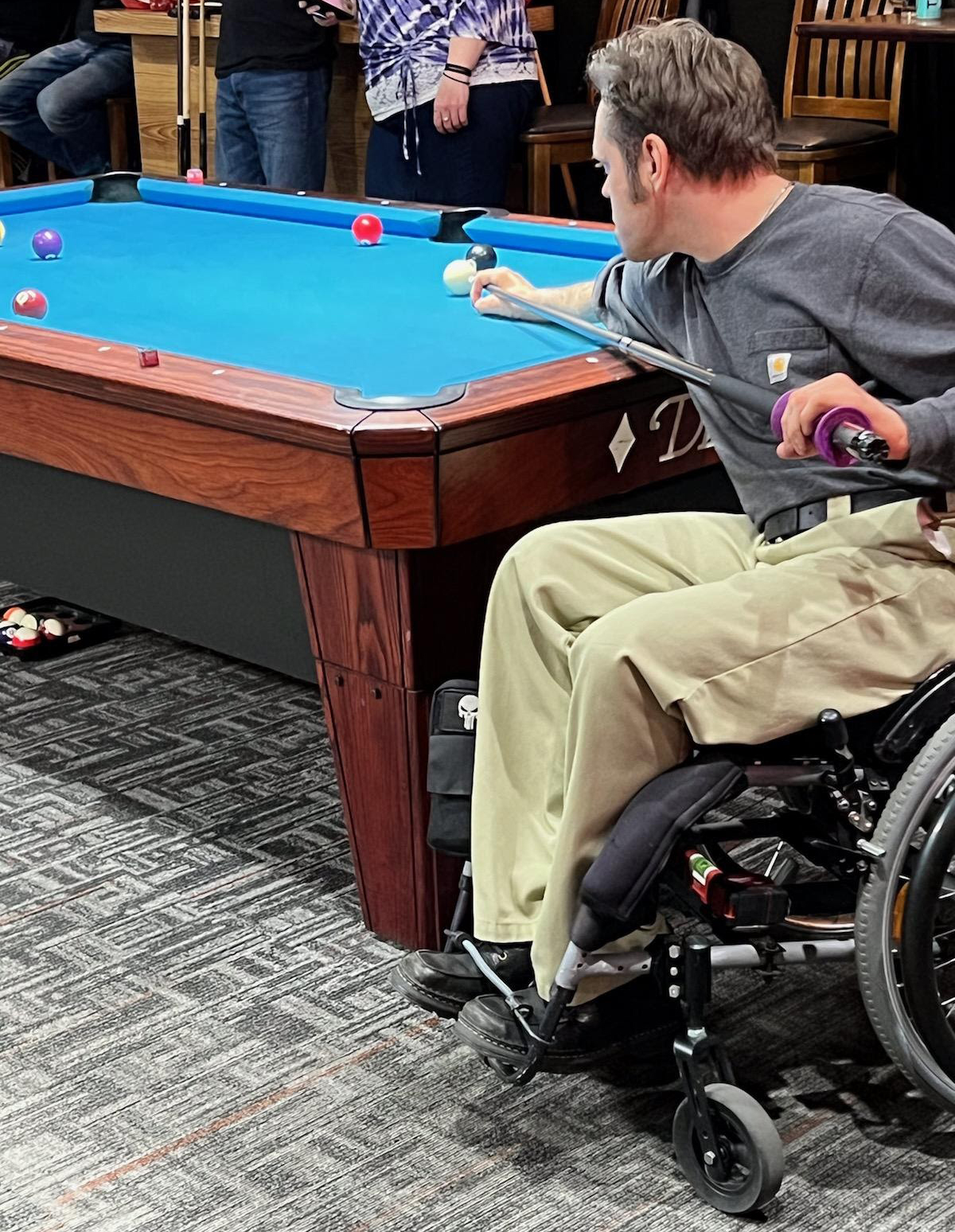 Ouellette lining up his shot playing pool