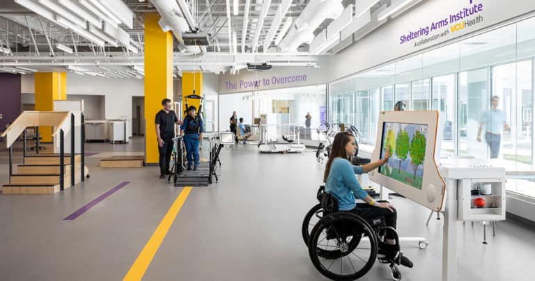 A woman wheelchair user in an acute rehab setting.