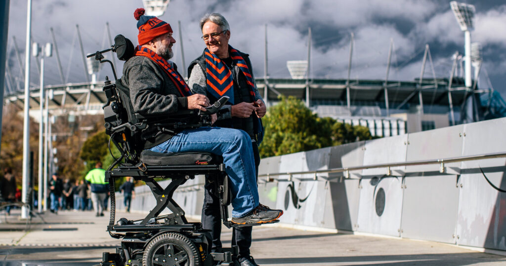 Man using elevated wheelchair seat