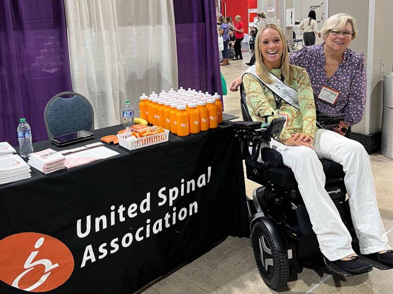 Two White women, one using a power chair
