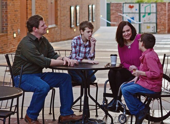 Wheelchair-using mom shown with her teenaged sons and husband.
