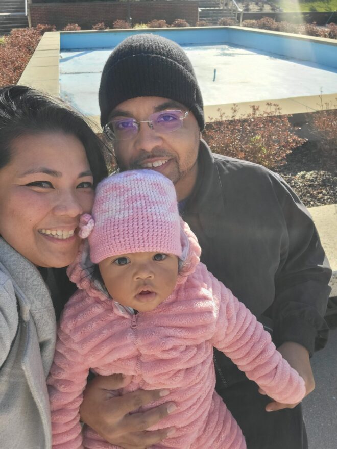 A wheelchair-using dad with his wife and baby daughter. 