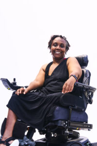 Engracia Figueroa, a vibrant Black woman power wheelchair user