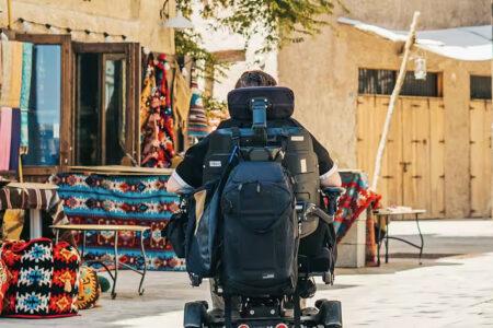 A power wheelchair user tours a Dubai souk.