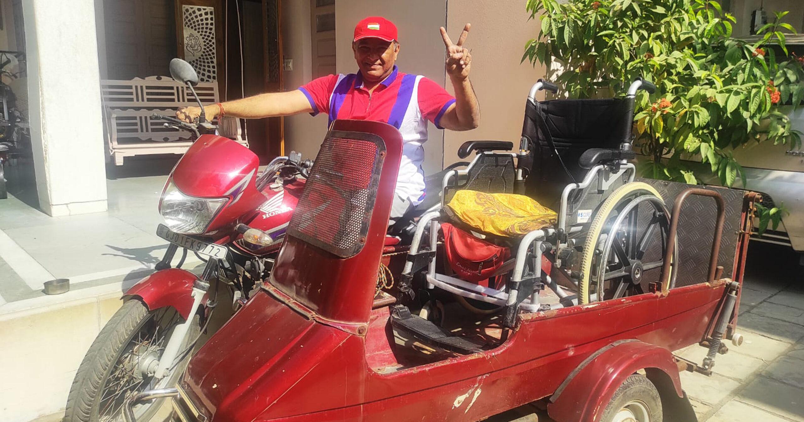 A man in India rides a modified motorcycle. His manual wheelchair is in the sidecar.