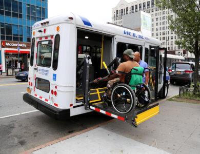 A Black wheelchair user takes a paratransit ride.