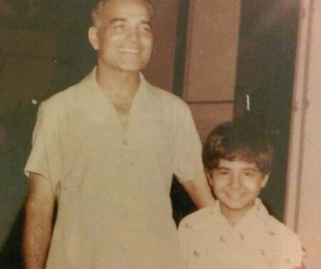 Ahuja as a young boy next to his father