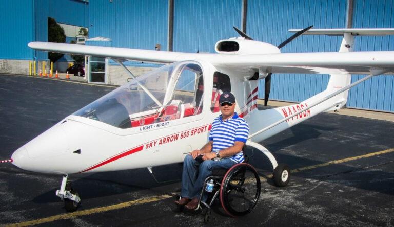 Ahuja sitting next to Sky Arrow plane
