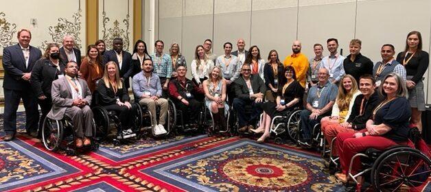 CAC group photo - dozens of wheelchair users in hotel lobby