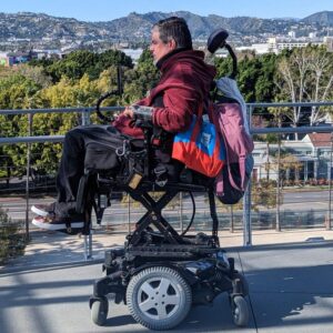 Javier Robles sits in his power wheelchair admiring nature