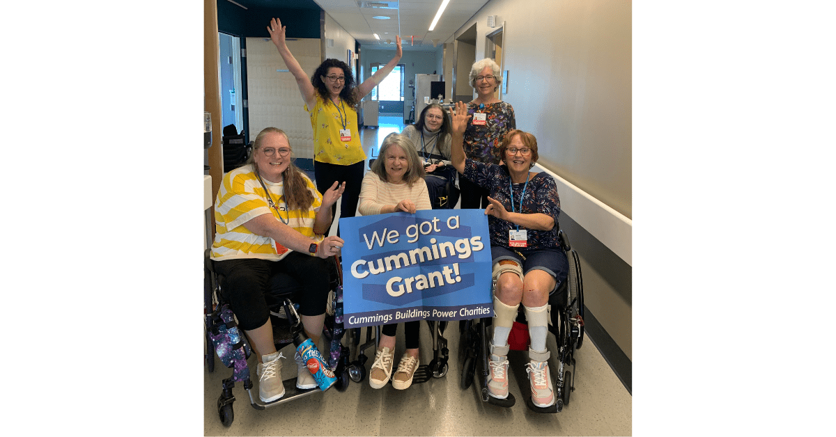 a group of wheelchair users celebrate winning the cummings award