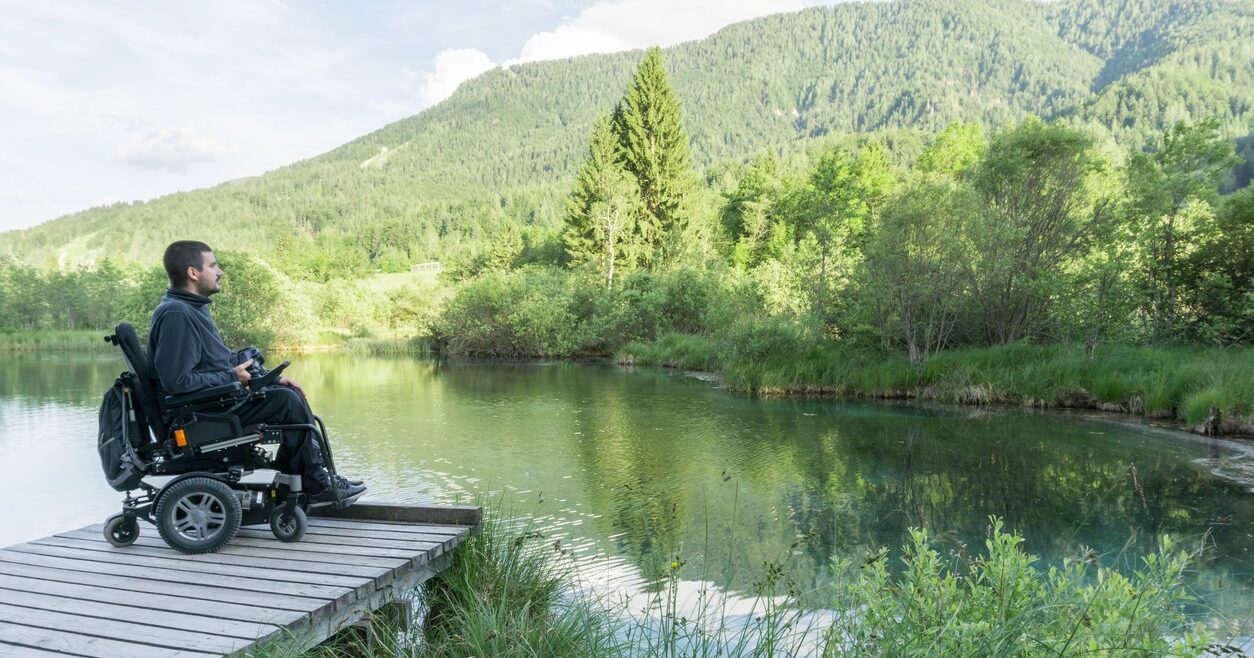 power wheelchair user near the lake in nature