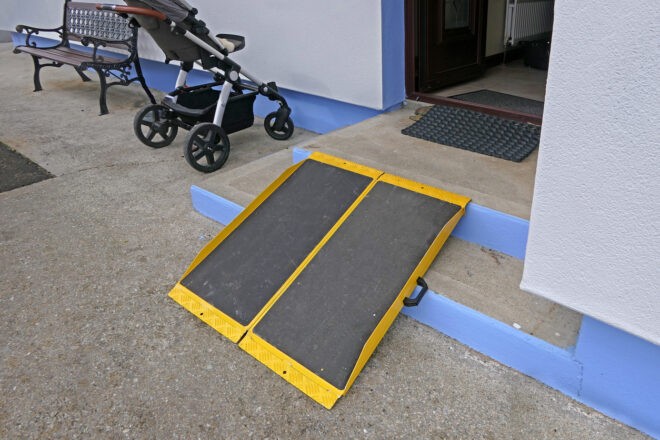 Portable foldable Wheelchair Ramp to the front of a building