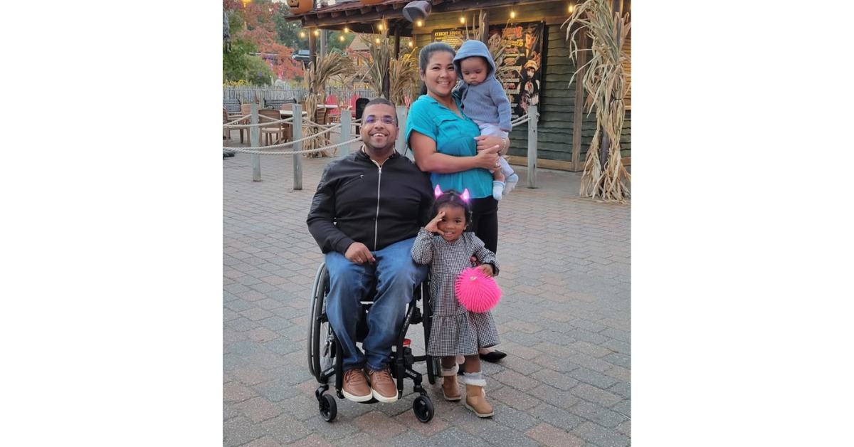 lesly st. louis, a black man and wheelchair user, with his family.