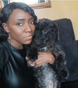a woman takes a selfie with her black dog