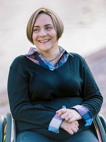 woman in wheelchair with short blonde hair laughing