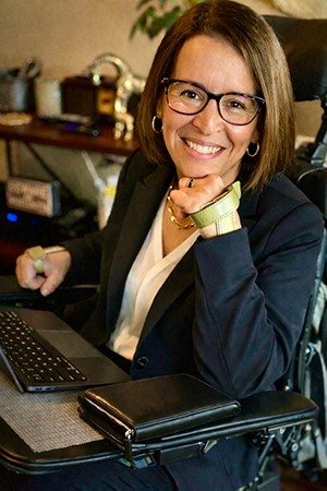 business woman in wheelchair with keyboard in lap
