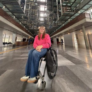 woman in wheelchair in large atrium