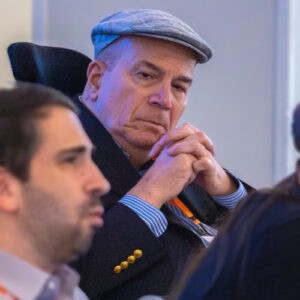 man wearing cap listening intently